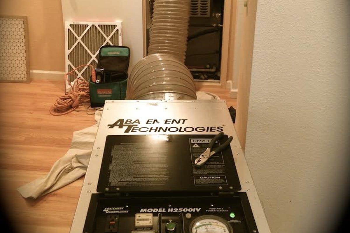 Professional negative-air duct cleaning machine hooked up to a home's duct system