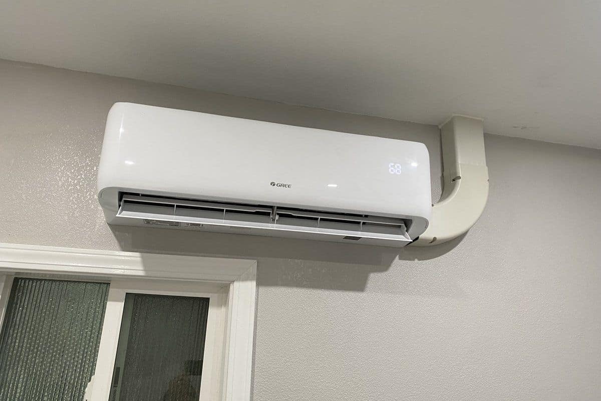 Ductless mini split indoor head mounted on a white brick wall in a Contra Costa County home