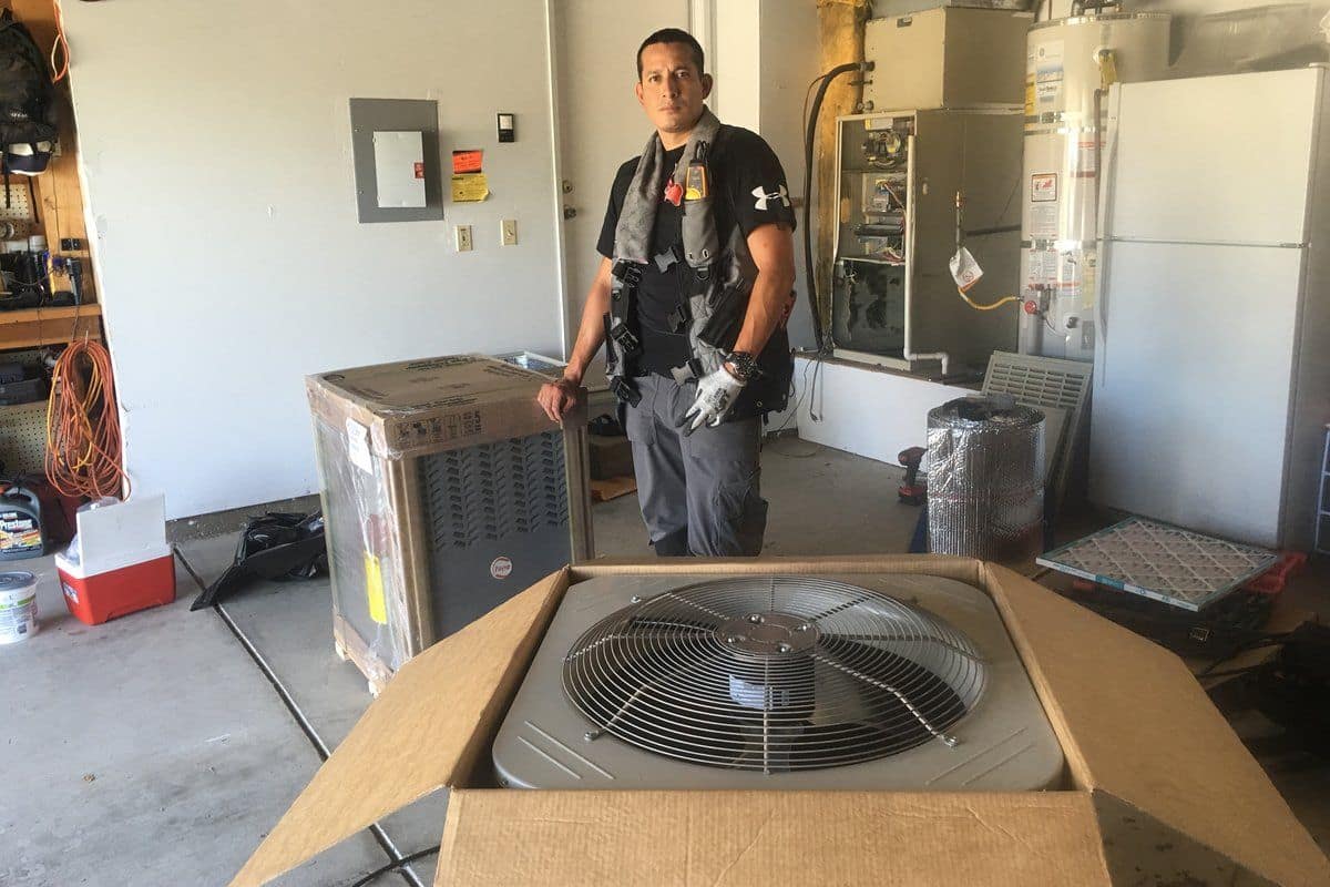 MDB Same Day HVAC technician with a brand-new furnace and condenser ready for a full home system installation